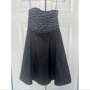 Strapless black mini dress.